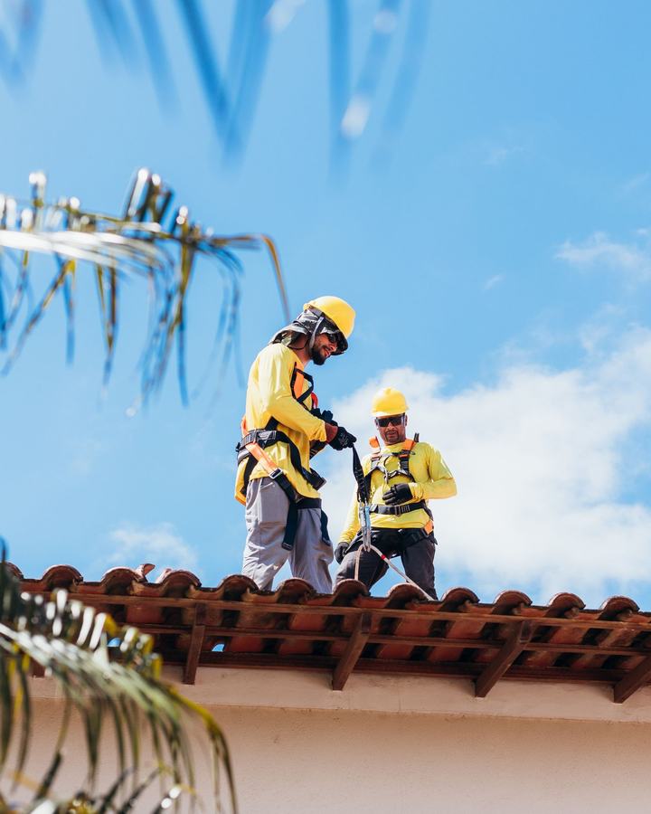 Roofers working on a tile roof