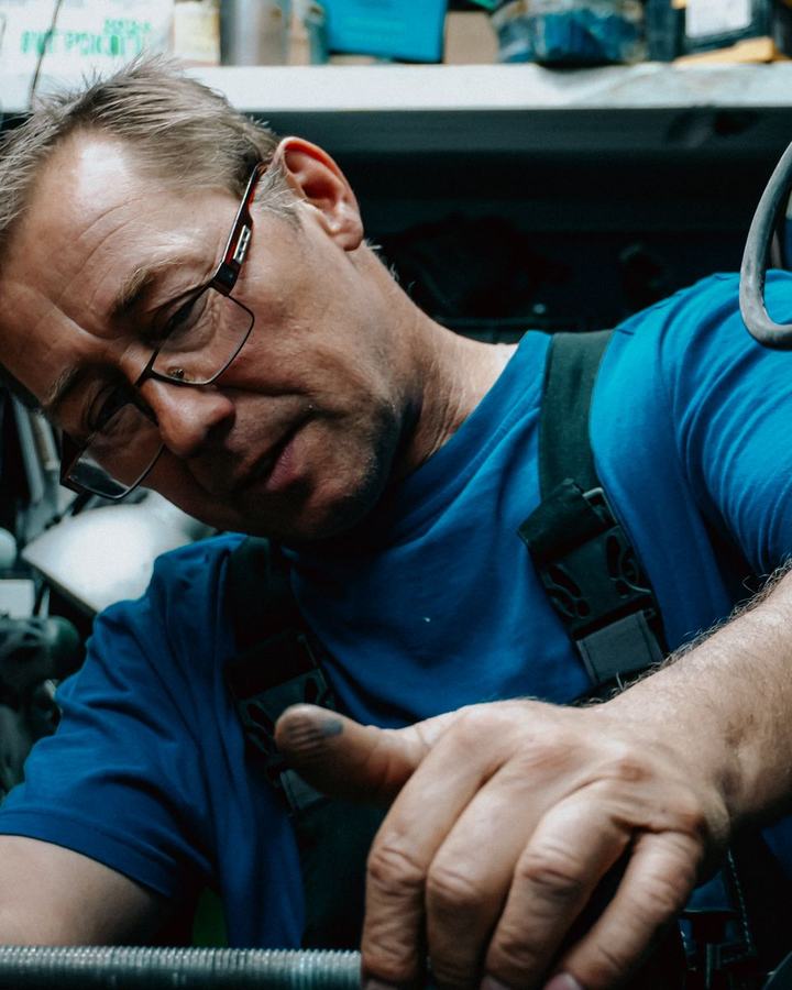 Auto mechanic working on an engine