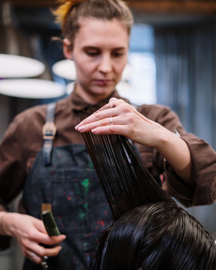 Hair stylist working with a client